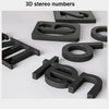 Eine Sammlung von schwarzen 3D-Stereo-Zahlen aus Material, präsentiert auf einer weißen Oberfläche.