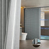A modern bathroom featuring a magnetic shower curtain with a waffle texture and vertical blinds.