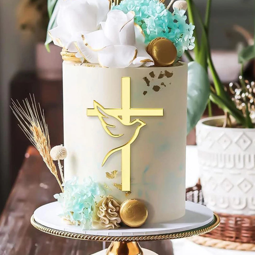 A white cake decorated with gold acrylic cross toppers and light blue floral accents.