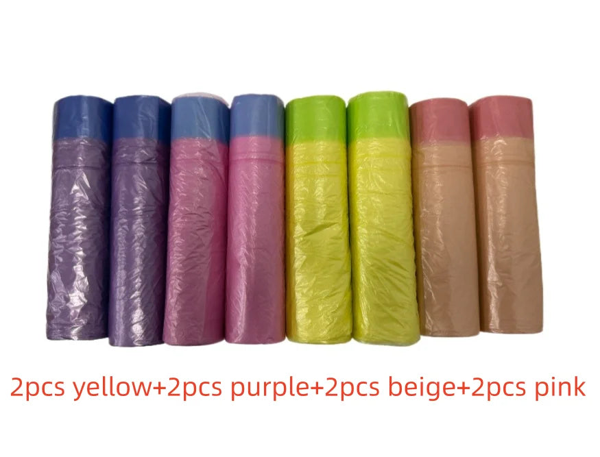 A row of 10 scented drawstring trash bags in various colors including yellow, purple, beige, and pink.