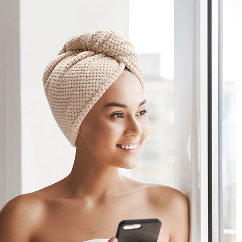 A woman smiling while wearing a beige soft microfiber hair drying towel wrap.