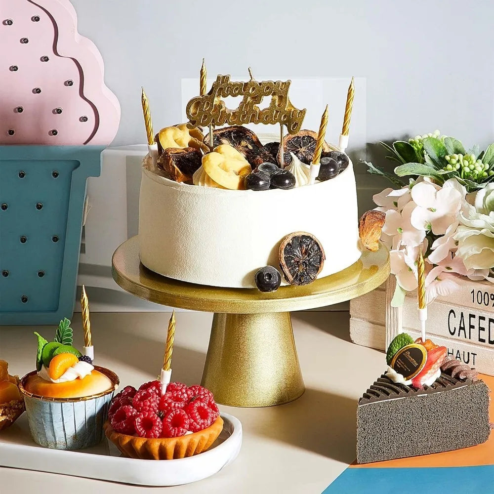 Mehrstöckige Torte mit goldenen Kerzen und Früchten auf goldenem Ständer neben kleinen Desserts
