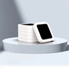 A stack of white reusable refill rings for kitchen trash cans displayed on a light gray surface.