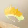 A yellow plastic crown-shaped bath shield cap is shown against a light background.