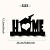 Black rustic metal wall hook key holder shaped like a house with a heart cutout.