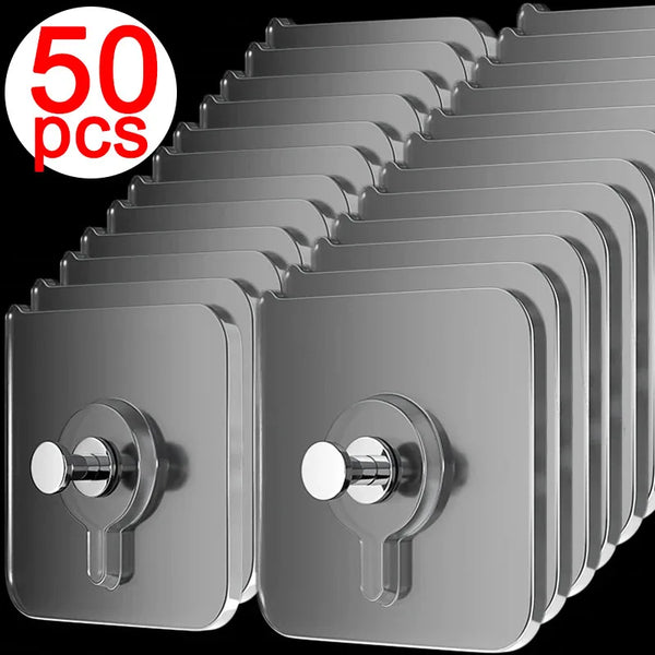 A stack of fifty clear, self-adhesive wall hooks designed for hanging frames and photos.