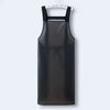A black waterproof kitchen apron hanging against a white background.