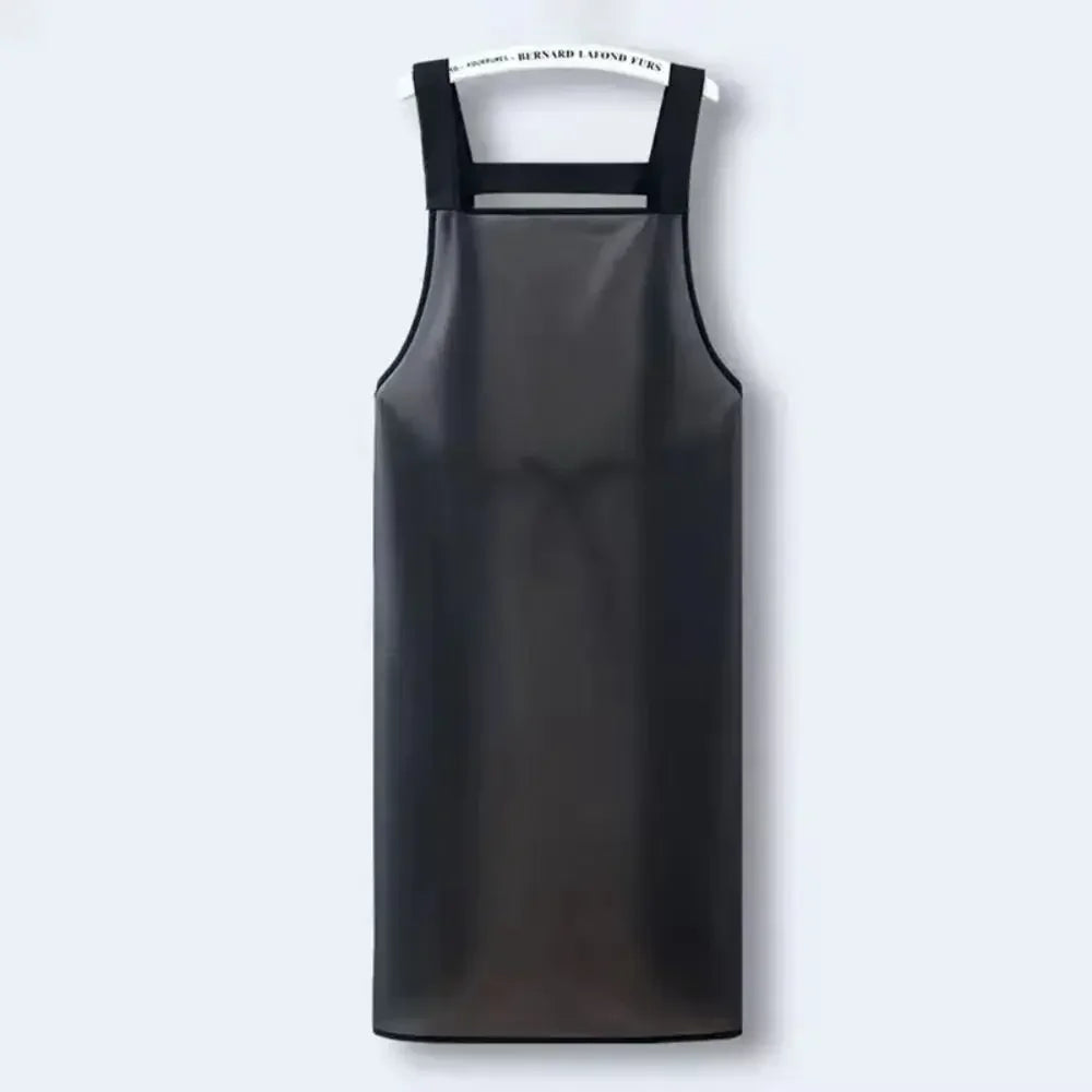 A black waterproof kitchen apron hanging against a white background.