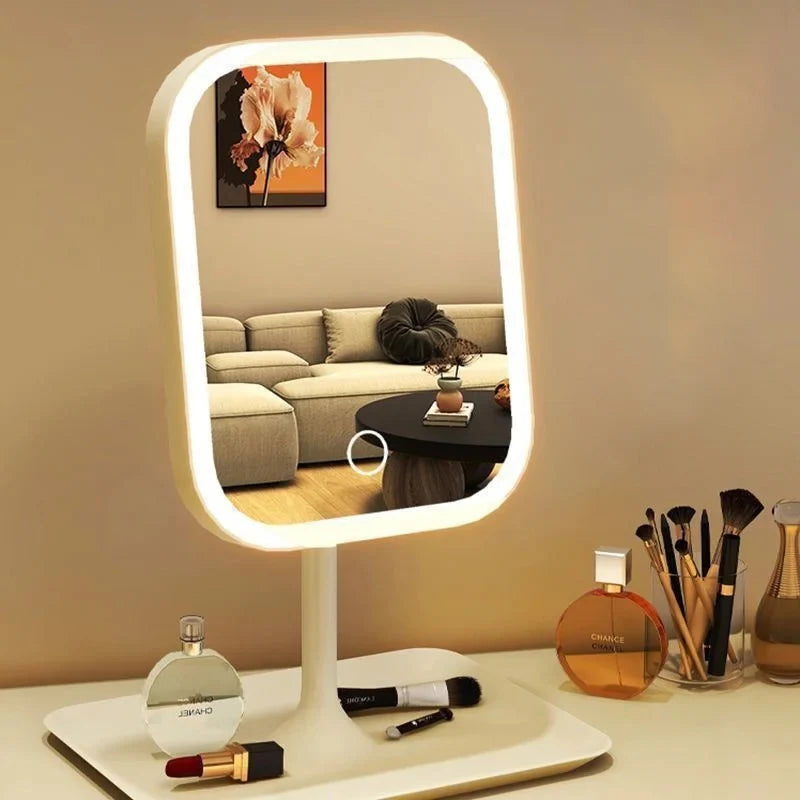An LED desktop vanity mirror with adjustable lighting is displayed on a white surface.
