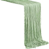 A light sage green boho sheer table runner draped in vertical pleats.