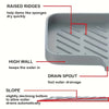 A silicone sink mat with raised ridges, a high wall, and a slope for fast water drainage.