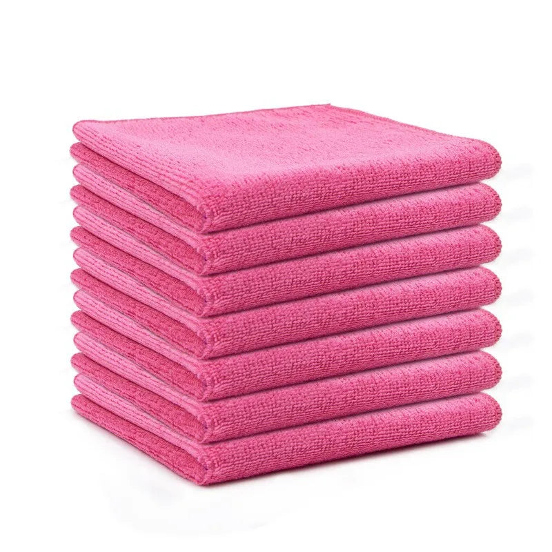 A stack of ten bright pink reusable microfiber cleaning cloths.