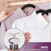 Hands are hanging a light pink shirt on a wooden hanger with non-slip velvet hangers and chrome hooks.