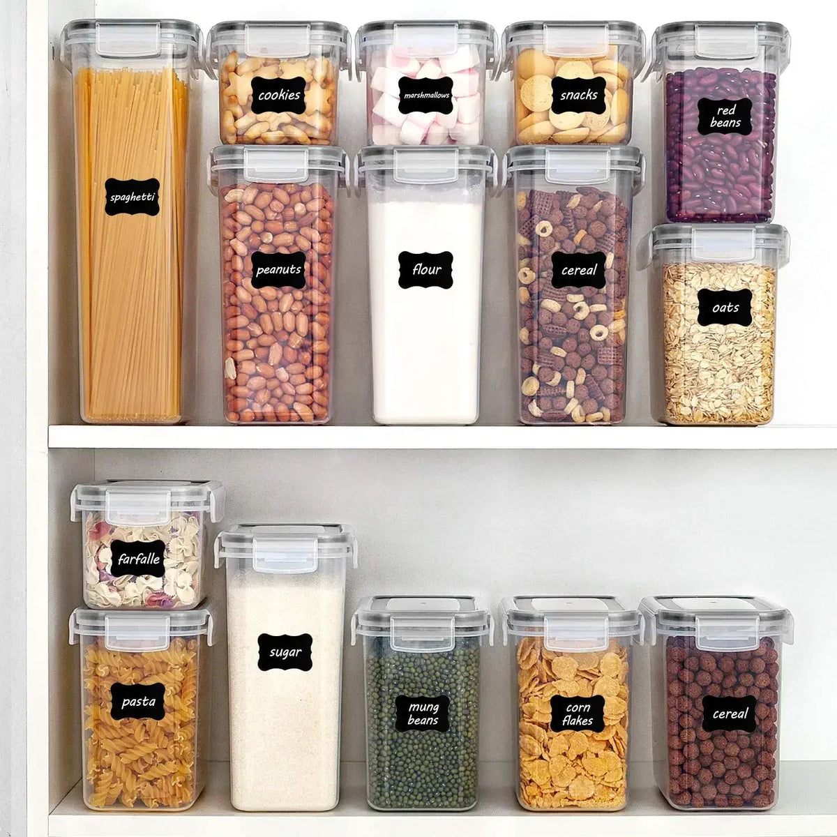 A collection of five clear plastic food storage containers filled with various dry goods like spaghetti, cookies, peanuts, fl