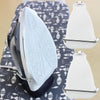 A white universal iron protective cover shield is shown resting on a patterned cloth.