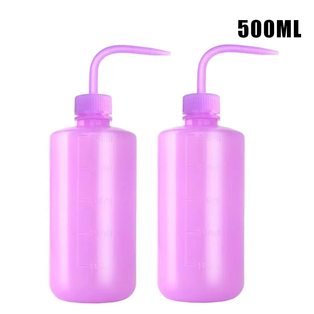 A pair of 500ml squeeze bottles with purple caps and measurement lines for tattoo solutions.