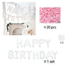 White balloon letters spelling HAPPY BIRTHDAY and pink tissue paper decorations for a birthday theme