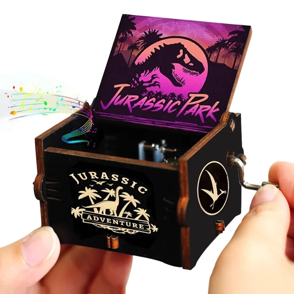 An antique wooden hand crank music box featuring a Jurassic Park themed box art with a dinosaur silhouette.
