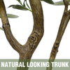 Natural looking tree trunk with green leaves and small red olives for indoor decor