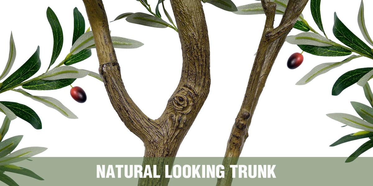 Natural looking tree trunk with green leaves and small red olives for indoor decor