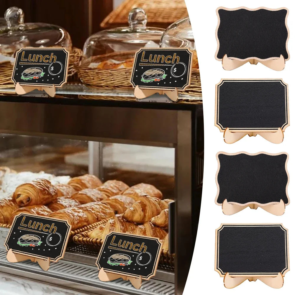 A set of mini wooden chalkboard signs with food illustrations displayed on a glass tray.