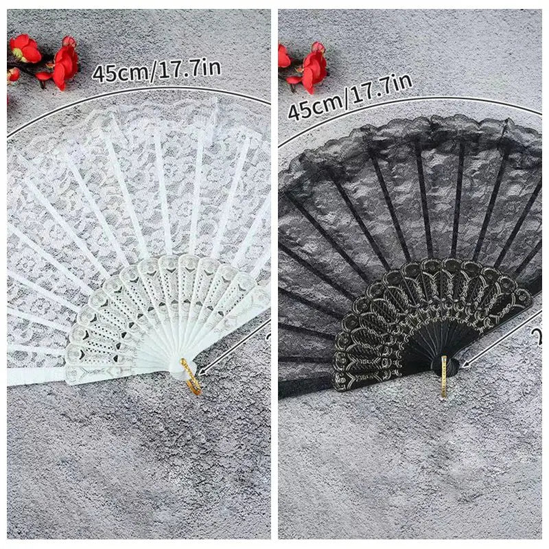 A white lace fabric folding hand fan with a black decorative edge and red flowers shown next to a black version.