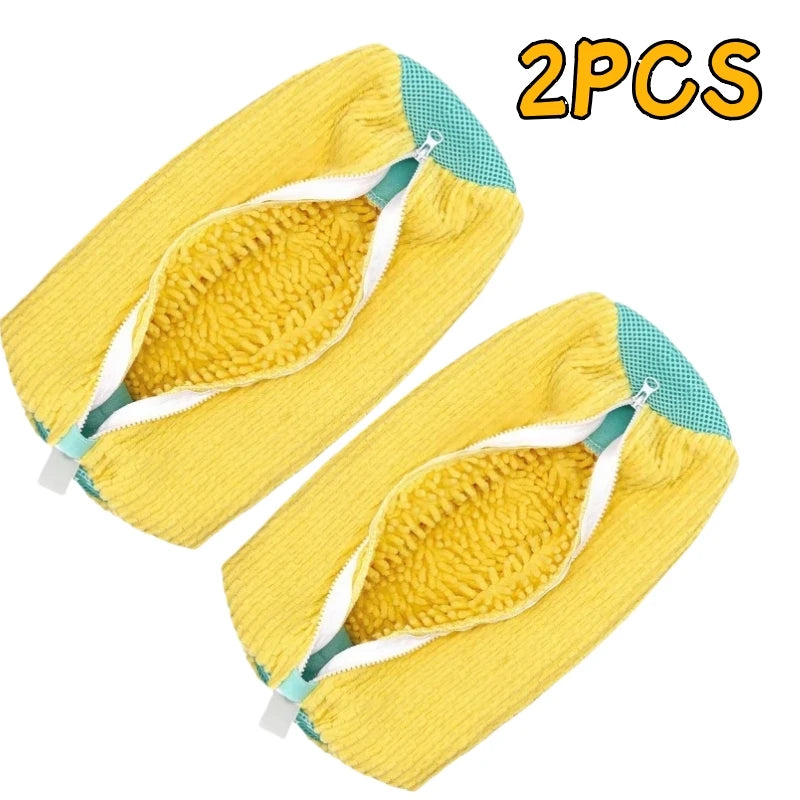 Two yellow shoe cleaning brushes with white handles and storage bags