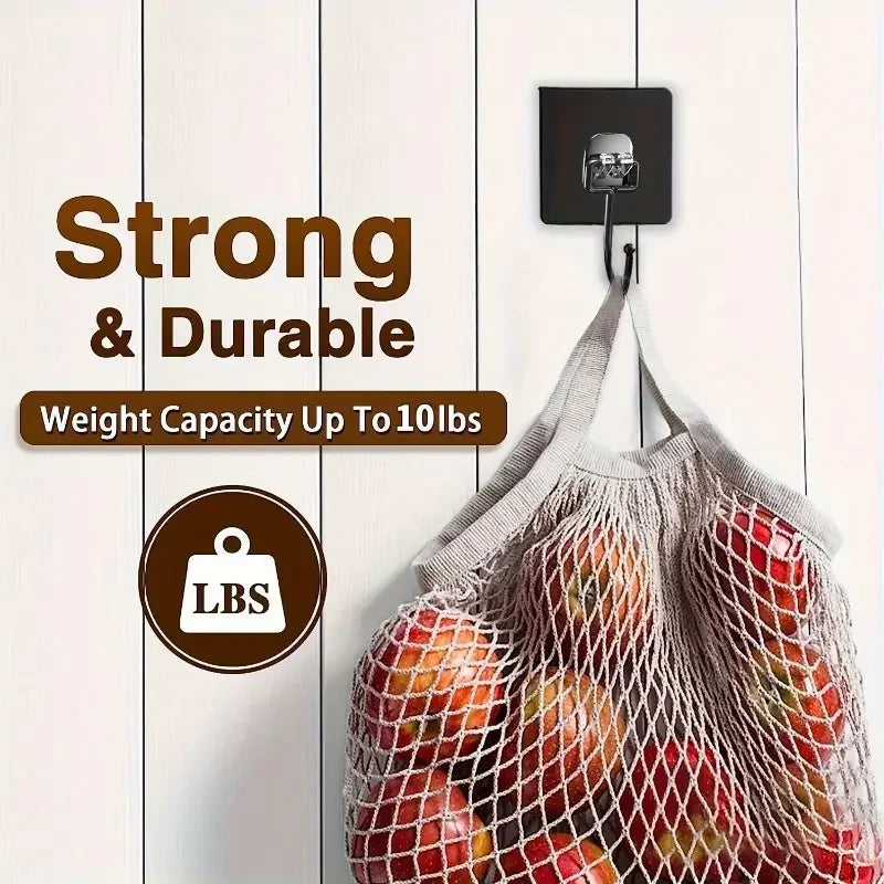 A mesh fabric bag filled with apples hanging from a black wall hook.