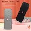 A black silicone faucet drainer pad is shown next to a smartphone, highlighting its toughness and food-grade material.