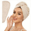 A woman is wearing a beige microfiber hair towel wrap on her head.