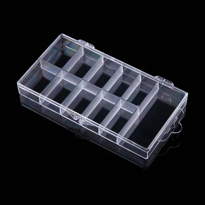 A clear plastic organizer box with multiple compartments for storing nail art supplies.
