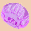 A solid satin wide brim shower cap in light purple is shown from above.
