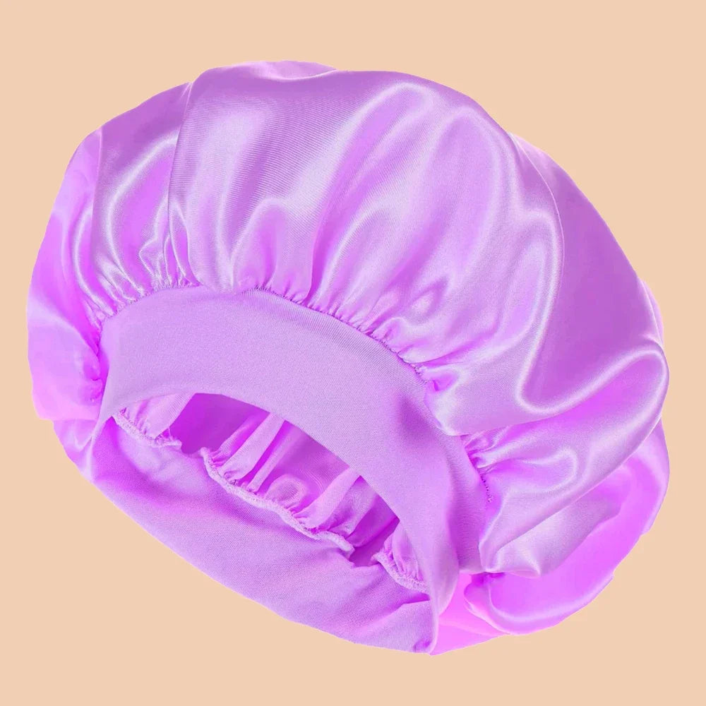 A solid satin wide brim shower cap in light purple is shown from above.
