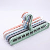 A set of collapsible rotating clothes hangers in various pastel colors, including pink, blue, and green.