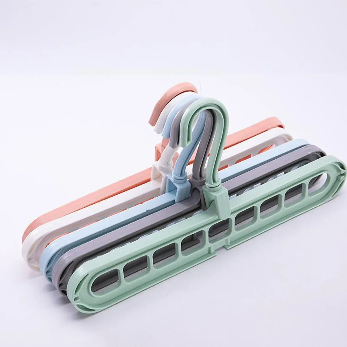 A set of collapsible rotating clothes hangers in various pastel colors, including pink, blue, and green.