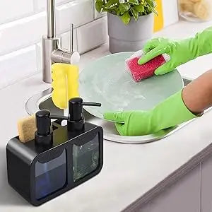 A hand wearing a green glove is using a pink sponge on a green plate next to a black kitchen soap dispenser set.