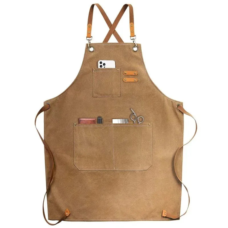 A brown canvas apron with leather straps and multiple utility pockets for tools and items.