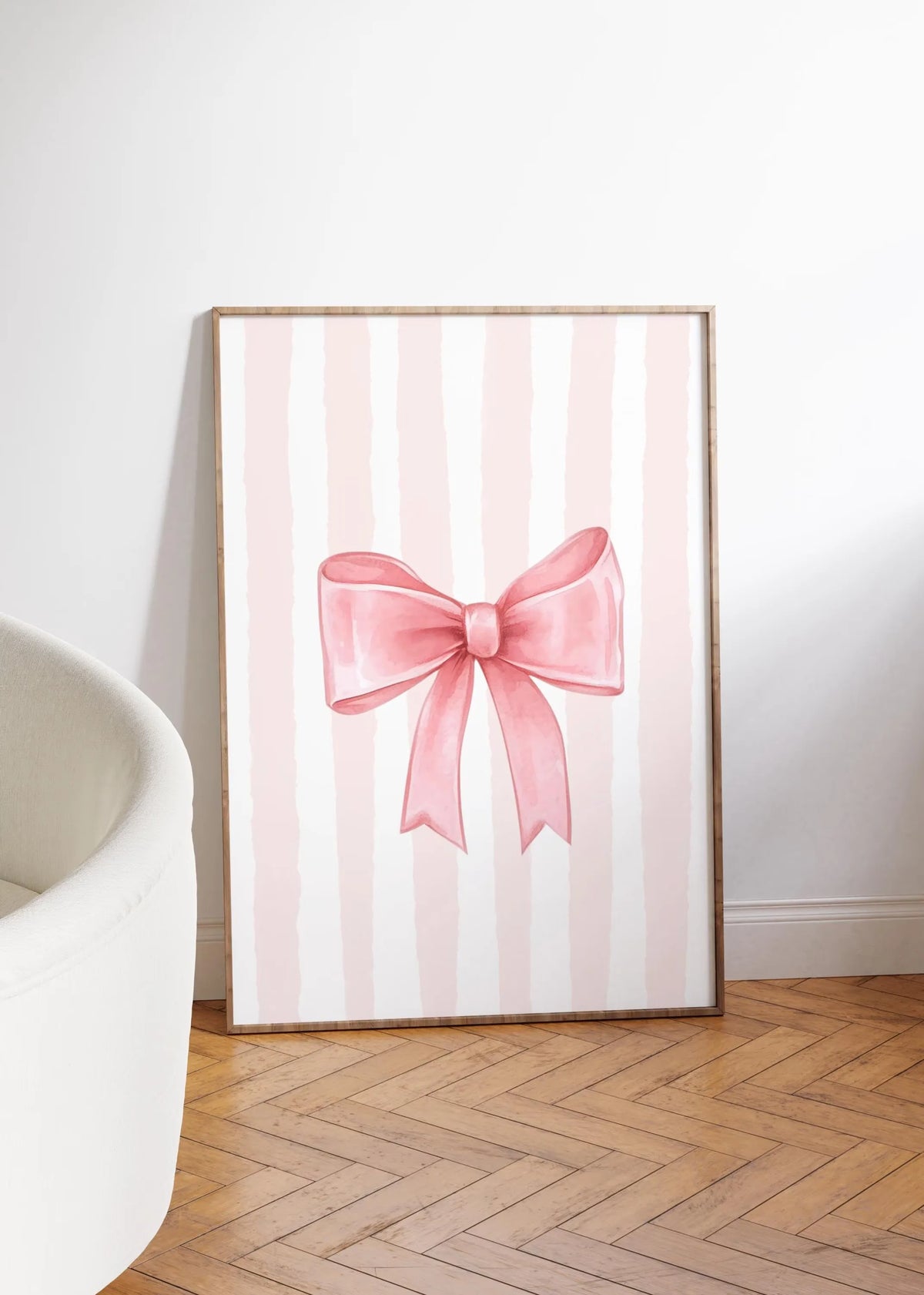 Pink striped canvas wall art featuring a bow design for nursery decor