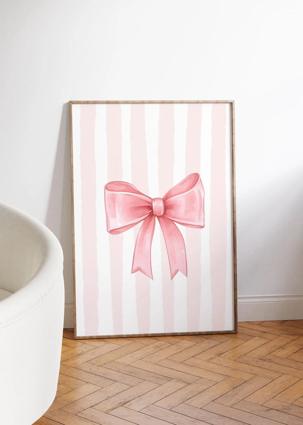 Pink striped canvas wall art featuring a bow design for nursery decor