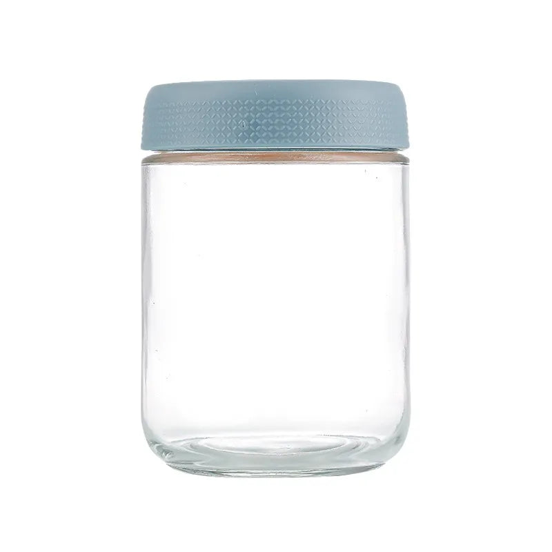 A clear glass meal prep jar with a light blue airtight lid.