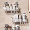 A display of stainless steel suction cup storage racks holding various bottles and cans.