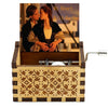 Antique wooden hand crank music box featuring a photograph of a couple.