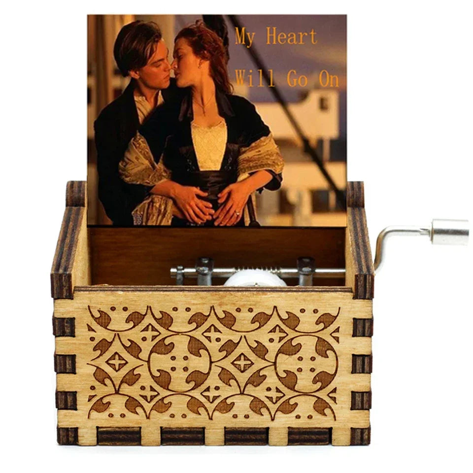Antique wooden hand crank music box featuring a photograph of a couple.