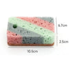 A rectangular block of multi-colored, eco-friendly cleaning sponge with pink, green, and gray stripes.
