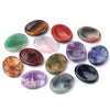 A collection of polished natural quartz thumb stones in various colors including red, green, purple, and brown.