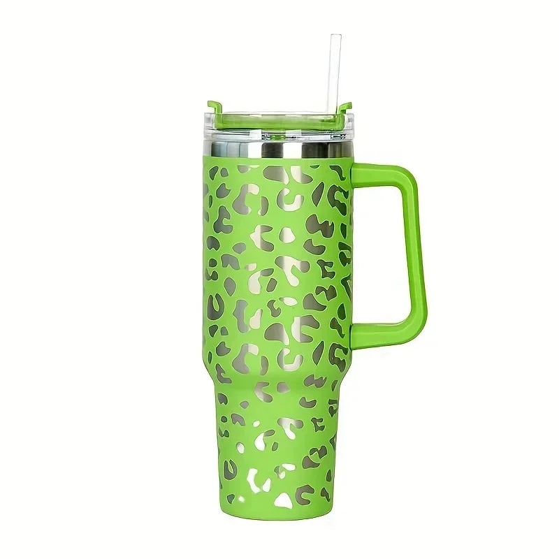 A lime green insulated stainless steel tumbler with a leopard print pattern and a handle and straw.