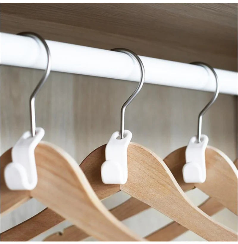 Nahaufnahme von Mini-weißen Kleiderbügeln an einem Holzgestell zur Kleiderschränkeorganisation.