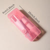 A pink silicone baby bottle cleaning set with a brush and bottle visible on a white surface.