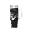 A stainless steel thermal tumbler with a silver straw featuring a portrait of a man.