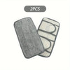 Two reusable microfiber mop pads for hard floors, one gray and one white.